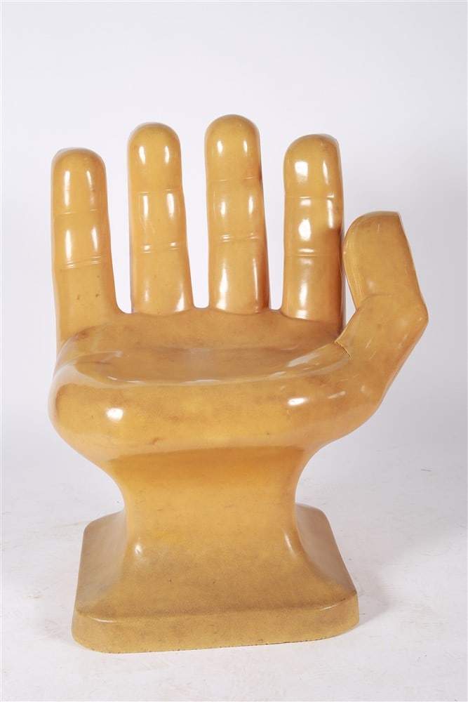 Taupe Plastic Hand Chair: Plastic. Height: 33 1/2", Length: 26", Depth: 21". Taupe plastic molded chair in the shape of a hand.