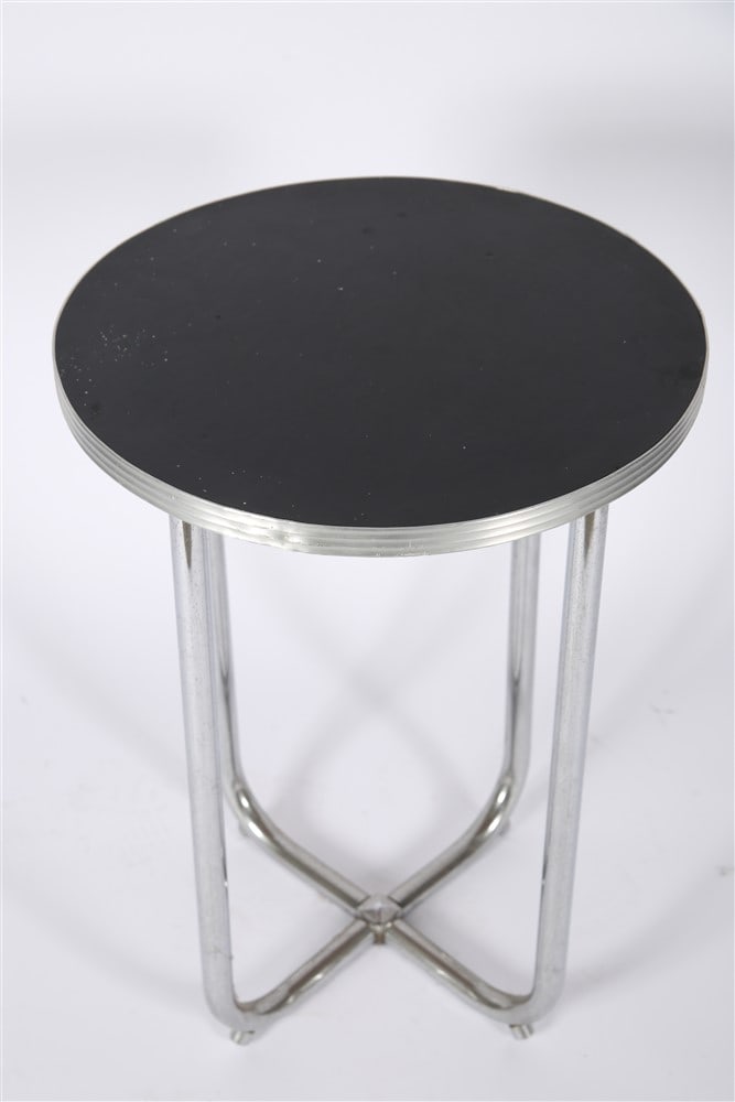 Bauhaus Style Round Chrome Side Table: Chromed metal, acrylic. Height: 25 1/4", Diameter: 17 1/2". Bauhaus style round table with chrome tubular frame and black acrylic top. Similar in style to works by Wolfgang Hoffmann.