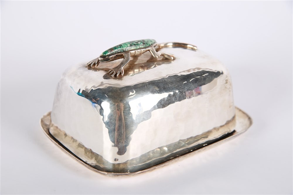 Emilia Castillo, Silver Plated Butter Dish: Emilia Castillo (Mexican). Silver plated copper, malachite. Height: 3 1/4", Length: 6", Depth: 4 3/4". Silver plate lidded dish with a malachite stone inlay lizard at top by the artist Emilia Castillo