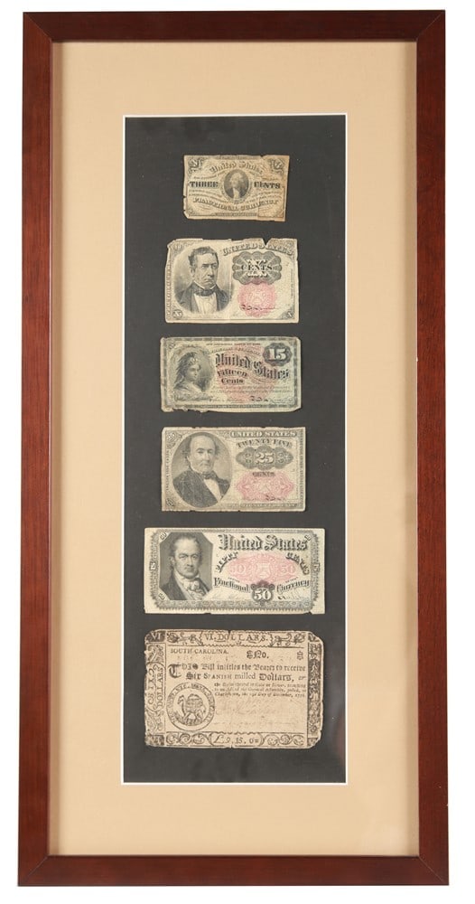 Framed Fractional Currency: Paper currency. Frame: 21 1/2" x 10 1/2". Sight: 16" x 5 1/2". Six pieces of American paper currency consisting of a 3-cent note, 10-cent note, 15-cent note, 25-cent note, 50-cent note, and a South Ca