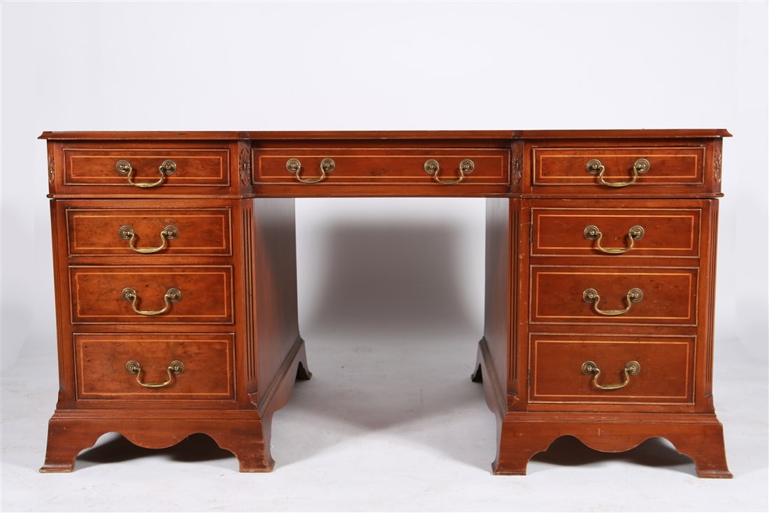 Mahogany Leather-Top Partner's Desk: Mahogany, leather, brass. Height: 30", Length: 39", Depth: 35 1/4". Mahogany desk with green tooled leather top. One side with nine drawers, the other side with three drawers and two doors. Brass