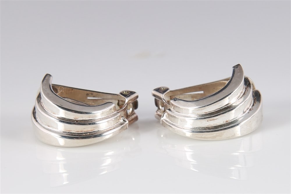 Christian Dior Sterling Clip-on Earrings: Christian Dior (French, 1905-1957). Sterling silver. Height: 1". Weight: .37 ozt. Christian Dior clip-on earrings in a ribbed design. Marked "Chr. Dior, PAT 2733491" at back.