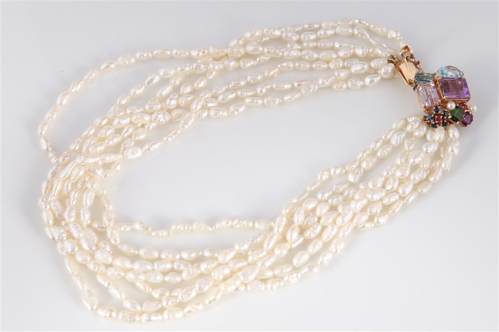 14k Freshwater Pearl Semi-Precious Stone Necklace: One lady's freshwater pearl necklace consisting of seven strands of freshwater pearls, each measuring approx. 16" in length. With a 14k yellow gold clasp set with the following: 1 rectangular cut genu