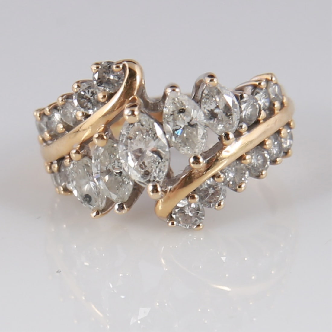 14k Marquise and Round Diamond Cocktail Ring: 14k yellow gold, diamond. Ring size: 4 1/2. Weight including stones: 5.1 grams. 14k yellow gold ring with 18 round cut diamonds and 5 marquise cut center diamonds. Marked 14k. Total weight with diamon