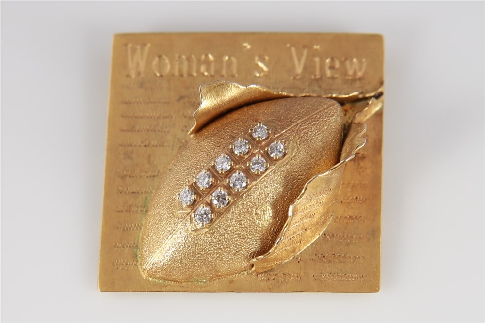 14k Diamond "Woman's View" Football Pendant: 14k yellow gold, diamond. Height: 1 1/4", Length: 1 1/4". Weight including stones: 8.8 grams. 14k yellow gold slide pendant that reads "Woman's View" with a football decorated with 10 round cut diamon