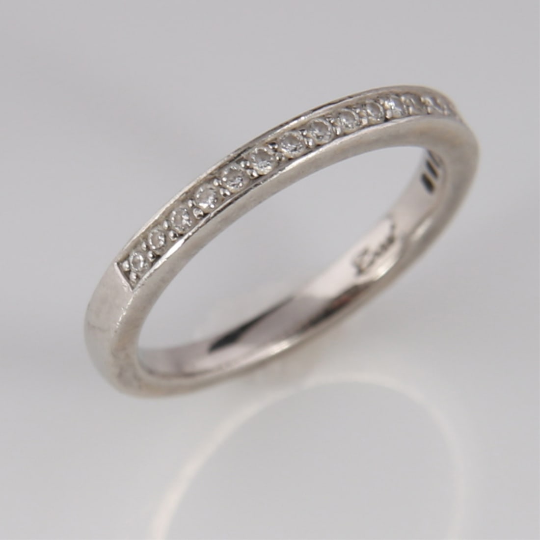 Platinum Diamond Band: Platinum, diamonds. Ring size: 5.75. Weight including stones: 4.4 grams. 95% platinum band set with 19 round cut diamonds. Total weight: 4.4 grams.