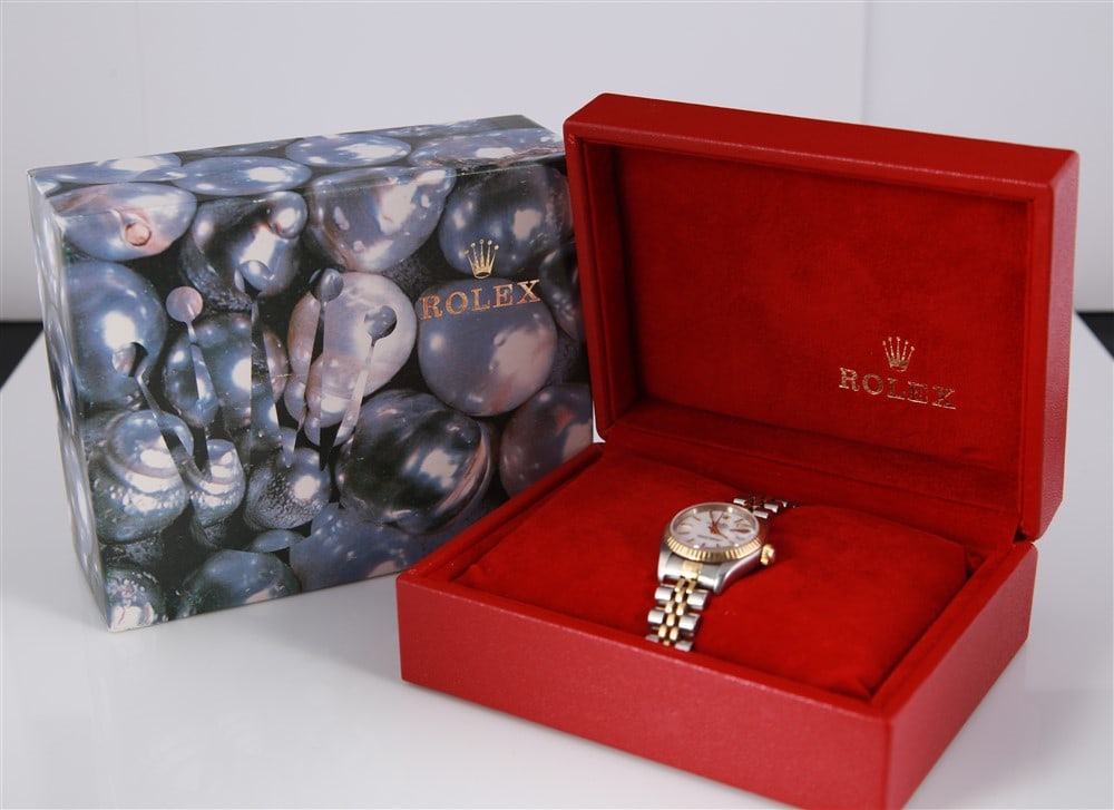 Rolex, Lady's Oyster Perpetual Datejust Watch: Rolex. Oyster Perpetual Datejust. Stainless steel, 18k yellow gold, 2002. Style no. 79173. Stainless steel and 18k yellow gold lady's Rolex Oyster Perpetual Datejust wristwatch. Comes with red Rolex b