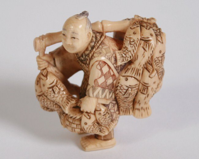Carved Ivory Netsuke, Japanese, 20th C.: Carved ivory netsuke. Japanese, 20th century. Depicting a fish seller. Height 2". Condition: Appears fine.