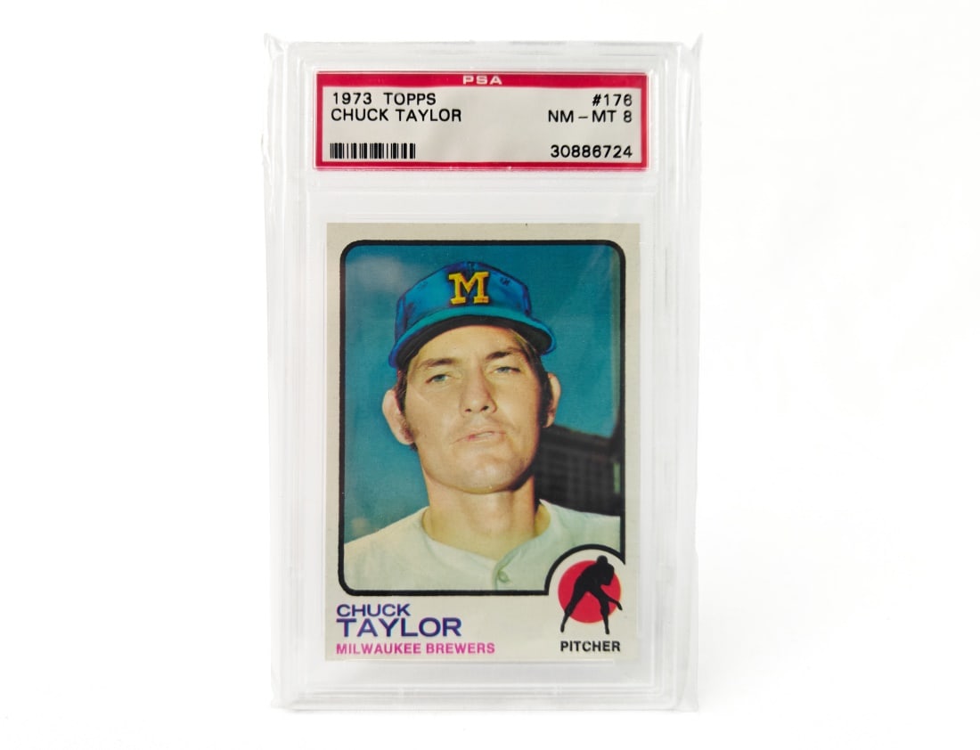 1973 Topps Chuck Taylor Baseball Card - PSA 8: A Topps Chuck baseball card for the 1973 MLB season by Topps. The card has been slabbed and graded by PSA.