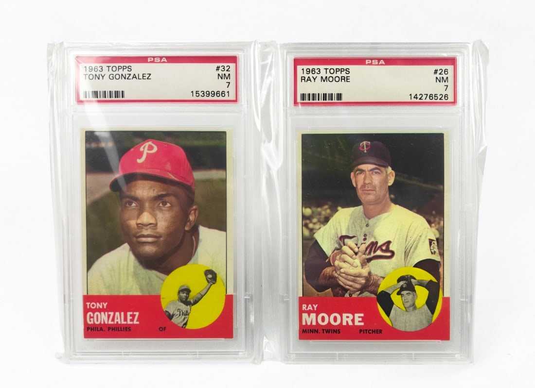 Set of 2 PSA Graded 1963 Topps Baseball Cards: Both cards are by Topps for the 1963 MLB season. Both cards have been graded and slabbed by PSA. Included players: Ray Moore - PSA 7 Tony Gonzales - PSA 7