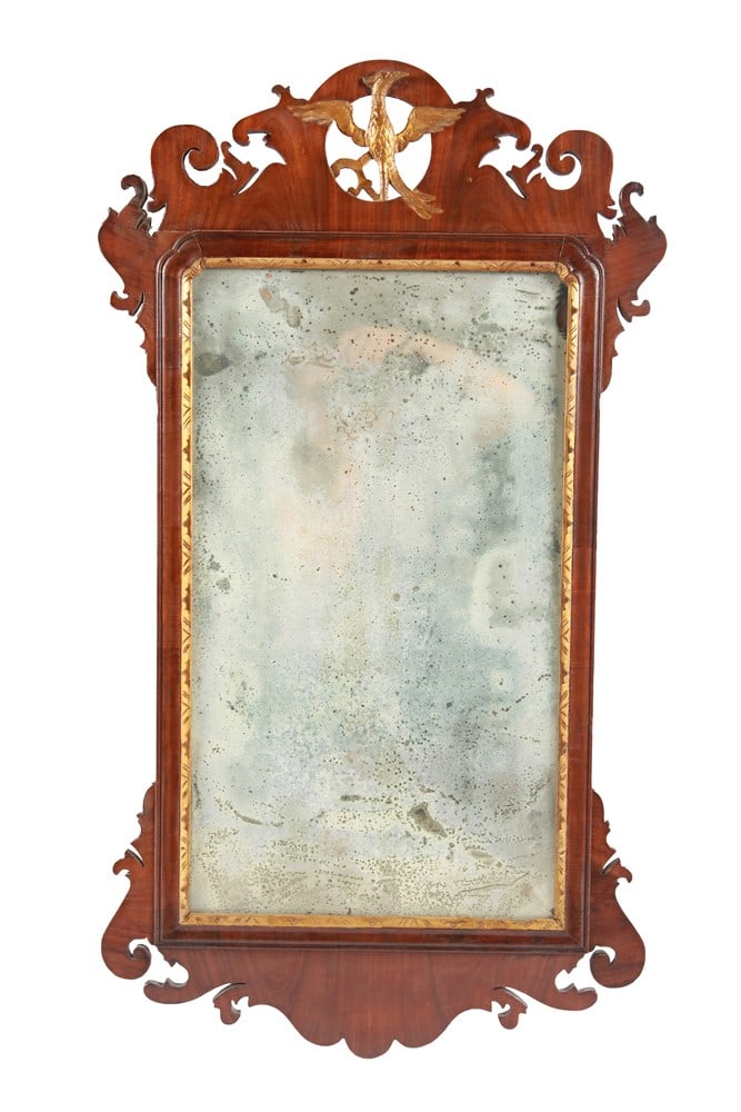 American Federal Style Mirror: Walnut, glass. 36 1/2" x 20 1/4". Scrolled walnut and gilt Federal style mirror with gilt eagle to the top.