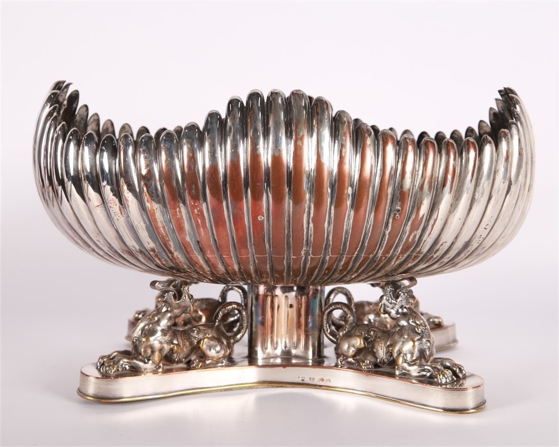 Silver Plated Lion Foot Centerpiece Bowl: Silver plate. Height: 10 1/4", Length: 17 1/2", Depth: 11 1/2". Silver plated centerpiece bowl supported by four lions. Marked with maker's mark to the side of the base.