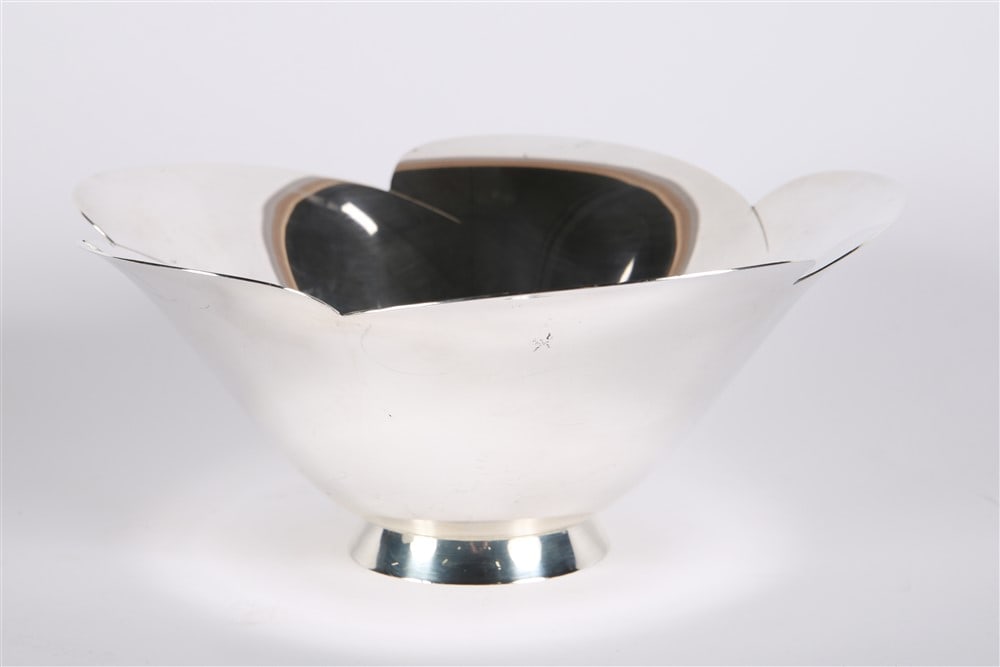 Tiffany & Co., Sterling Silver Bowl: Tiffany and Co. (American, established 1837). Sterling silver. Height: 4", Diameter: 9 1/2". Weight: 18.97 ozt. Tiffany & Co. sterling silver bowl. Flower shape with petal rim. Tiffany mark at bottom.