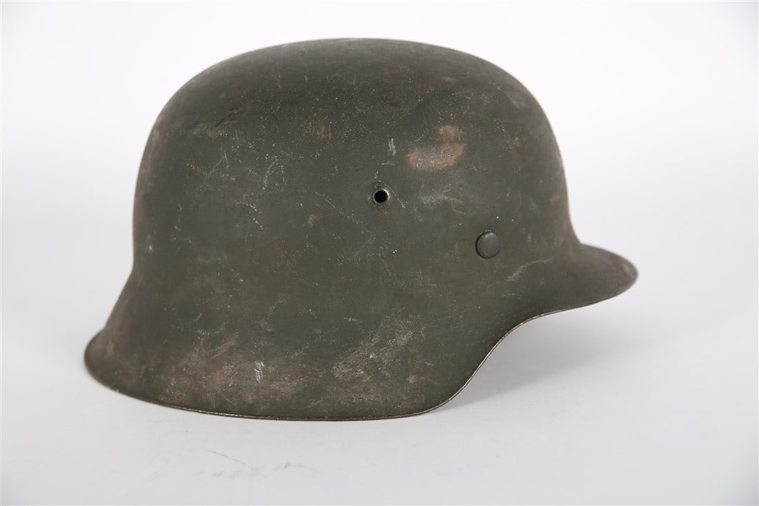 World War II German Combat Helmet: World War II German late war raw edge combat helmet. No chinstrap. No decals. Rbn number to liner. Size 66. 6" x 11 5/8".