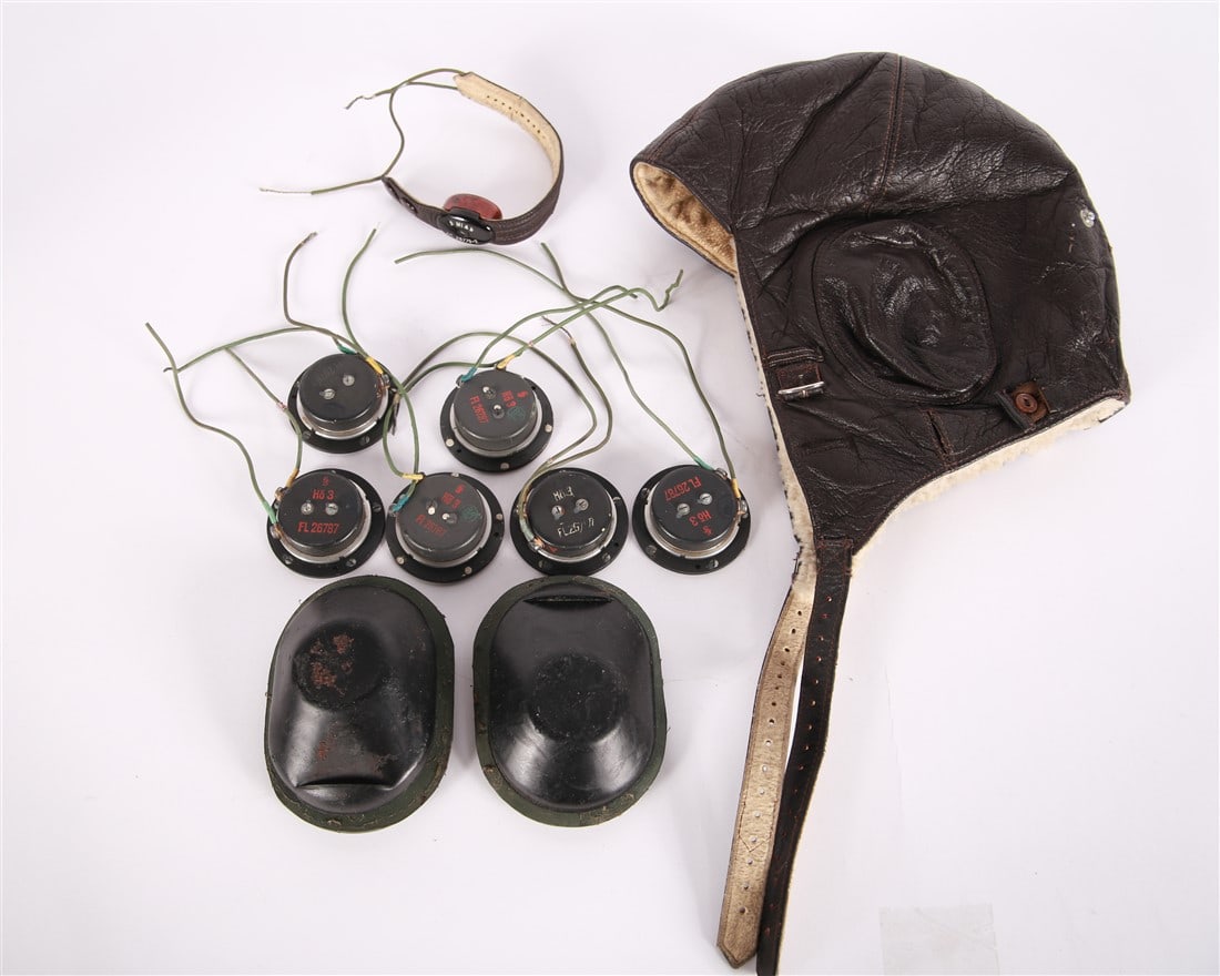 World War II German Luftwaffe Flight Helmet: World War II German Luftwaffe leather flight helmet. Model: LKpW101. With cord, throat microphones, and earphones.