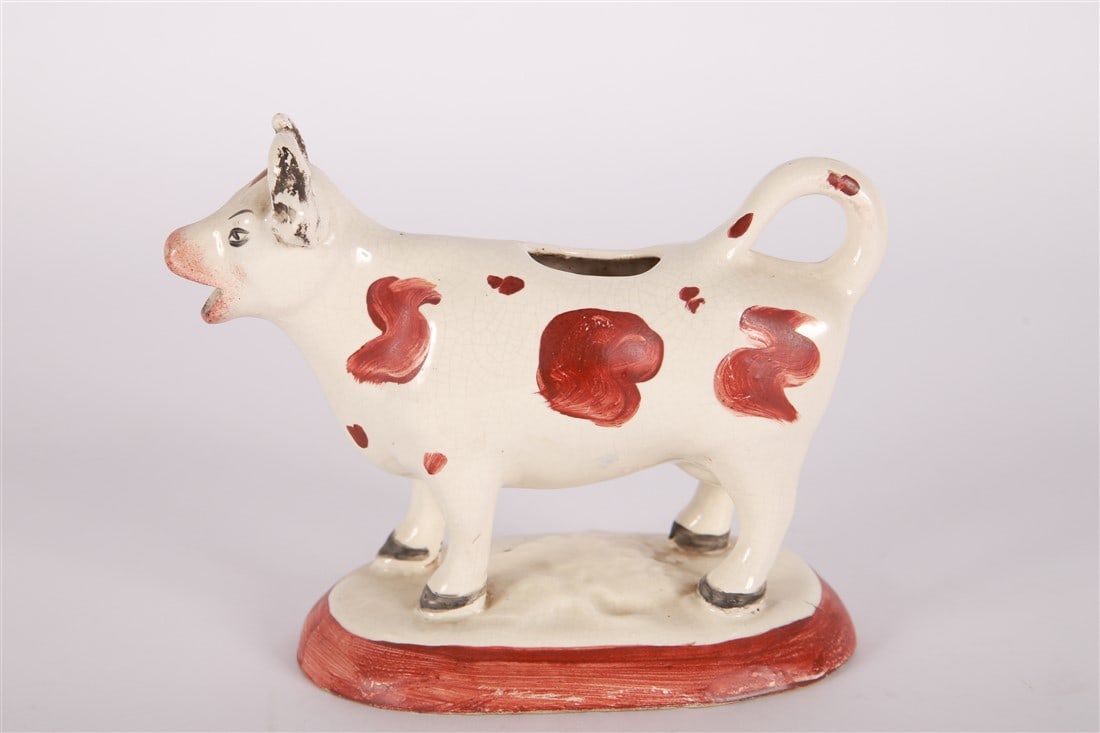 Staffordshire, Cow Creamer: Staffordshire (English, established 18th century). Earthenware. Height: 5 1/4", Length: 5", Depth: 3". Staffordshire cow creamer; a cream and brown cow on a cream and brown base.
