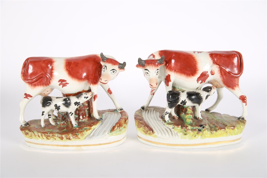 Staffordshire, Cow/Calf Pair: Staffordshire (English, established 18th century). Earthenware. Height: 8", Length: 8 1/4", Depth: 4 1/2". Matching pair of Staffordshire cows with nursing calves on a pastoral base.