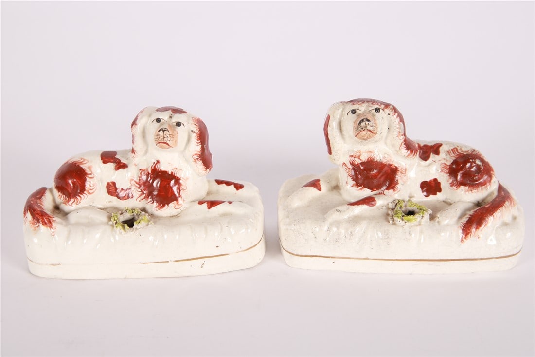 Staffordshire, Pair of Spaniel Pen Holders: Staffordshire (English, established 18th century). Earthenware. Height: 3 1/4", Length: 5 1/2", Depth: 2". Matching pair of Staffordshire spaniels reclining on a cream base. Hole at front can be used 