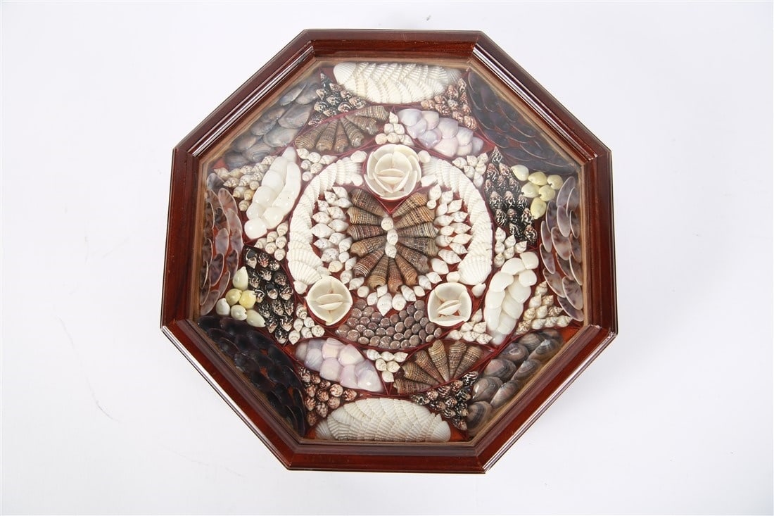 Sailor's Valentine: Wood, shells. Height: 2 1/2", Length: 10 1/8", Depth: 10 1/8". Sailor's Valentine comprised of multicolored shells in an octagonal wooden case. Marked "Made in Indonesia" at back.