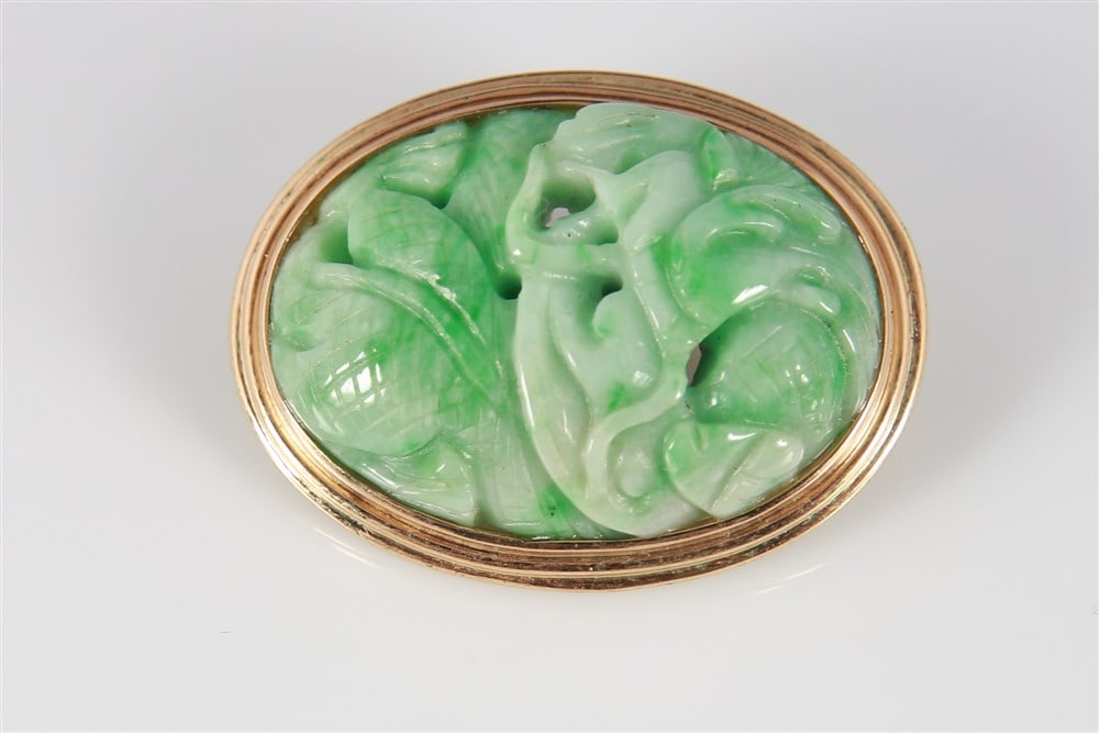 Gump's, 14k Yellow Gold Jade Brooch: Gump's, 14k yellow gold brooch with apple green jade center. Carved jade depicts a creature. Marked "Gumps 14K". 1 1/2" x 1". Provenance: Purchased directly from Gump's, 1986.