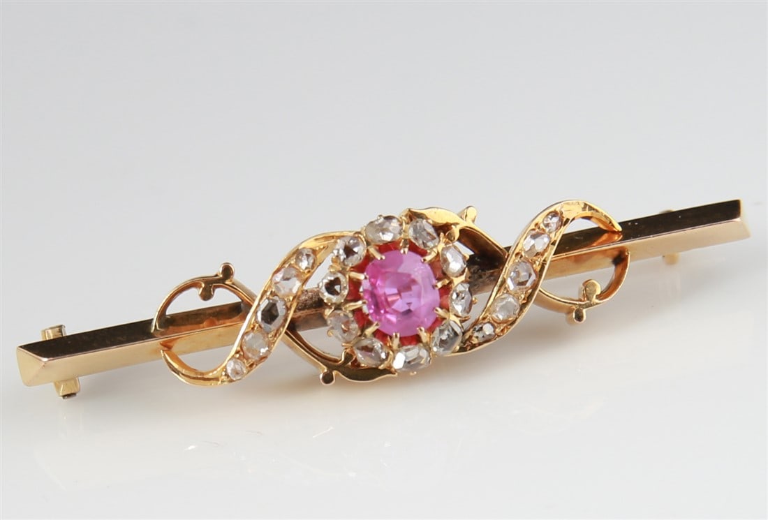 14k Yellow Gold Rose Quartz Diamond Bar Pin: One lady's rose quartz and diamond bar pin, yellow gold mounting stamped 14k, set with the following: 1 off round shape rose quartz at approx. 2.00cts approx. 2.0mm x 5.00mm; 20 rose cut diamonds at a