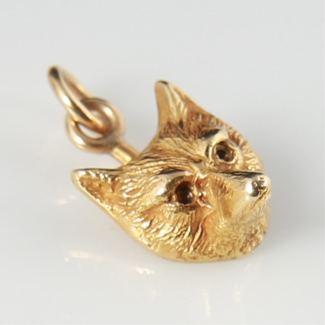 14k Yellow Gold Fox Head Charm: 14k yellow gold. 1/2" x 3/8". Weight: 2.1g. 14k yellow gold fox head charm. Marked 14K to the reverse.