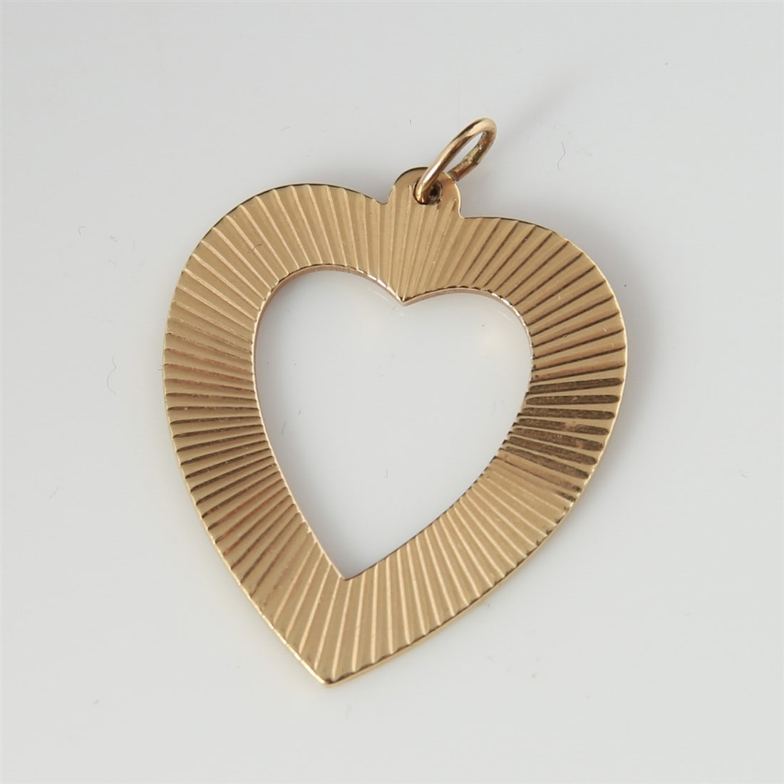 14k Yellow Gold Heart Charm: 14k yellow gold. 1 1/2" x 1 1/4". Weight: 7.8g. 14k yellow gold heart charm. On one side, the heart charm has a textured pattern. On the other side, the heart is engraved: "W.D.C. W.B.K. 8-25-62". Mar