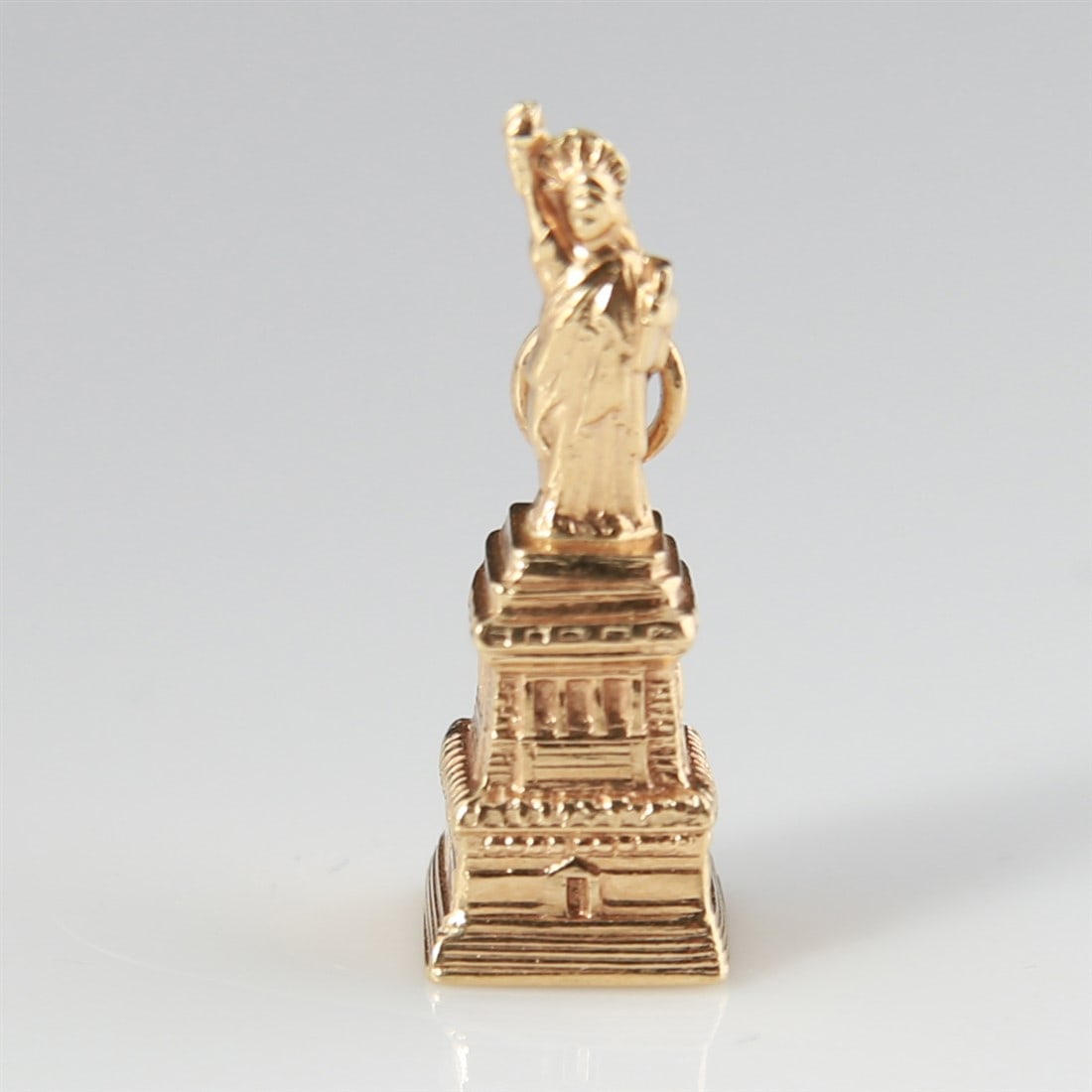 14k Yellow Gold Statue of Liberty Charm: 14k yellow gold. 1" x 3/8" x 3/8". Weight: 1.9g. 14k yellow gold Statue of Liberty charm. Marked 14K.