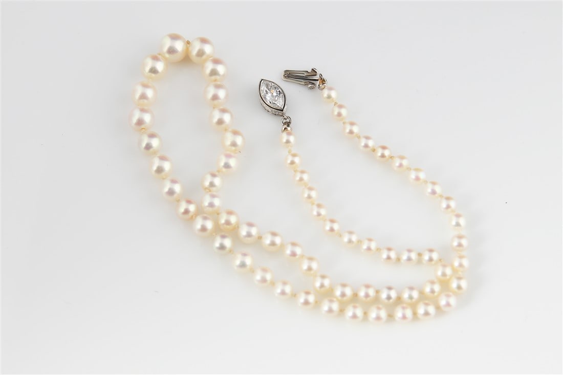 Natural Graduated Pearl Necklace, Diamond Clasp: One graduated strand of natural pearls consisting of 64 natural pearls and 1 cultured pearl, detailed as follows: 1 pearl at 13.40 grains, 2 pearls at 21.12 grains, 4 pearls at 38.72, 4 pearls at 29.6