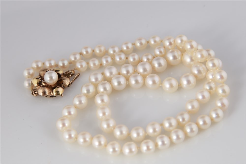 Cultured Pearl Necklace with 14k Yellow Gold Clasp: Cultured pearl necklace. Pearls measure 5 - 8mm. Necklace is 20" long. 14k yellow gold clasp.