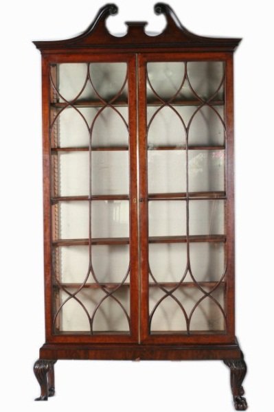 George III style Mahogany Cabinet, 19th C. English: George III style mahogany cabinet. English, late 19th century. Broken arch pediment carved with rosettes above dentil molding above pair mullion glazed doors enclosing shelves, raised on base with aca