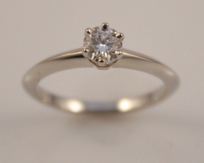 Tiffany & Co. Platinum and Diamond Solitaire Ring: Tiffany platinum and diamond solitaire ring. American, 20th century. Platinum band with round brilliant cut diamond; 0.31 ct. total weight, clarity VVS1, color D. Total weight 3.4 grams. Ring size 4 3