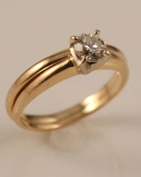 Ladies' 14K Gold and Diamond Engagement Ring: Ladies' 14 karat yellow gold and diamond engagement ring. 20th century. 14 karat yellow gold band set with one round European cut diamond, total weight 0.46 ct.,clarity VS2, color G. Together with sol