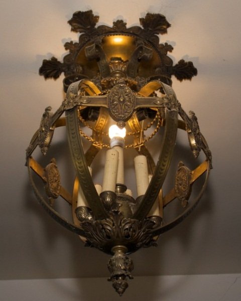 Bronze Renaissance Revival Ovoid Chandelier: Bronze Renaissance Revival ovoid chandelier. Late 19th century. Ovoid form seven-light chandelier suspended from an acanthus leaf motif ceiling escutcheon and having a horizontal band with medallions 