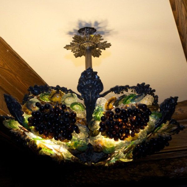 Venetian Hanging Light with Molded Glass Grapes: Venetian hanging light with molded glass grapes. Italian, early 20th century. Metal and wire shade with green, purple and brown molded glass spheres arranged in bunches of grapes. Height 18" x 25". Co