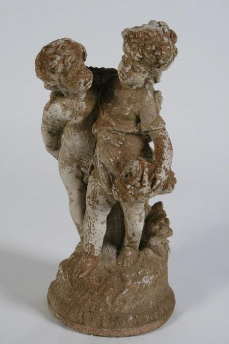 Cast Concrete Putti with Child: Cast concrete putti with child. Possibly 19th century. Depicting a putti beside a child holding a basket over a leaf motif decorated base. Height 20", width 9 1/2".