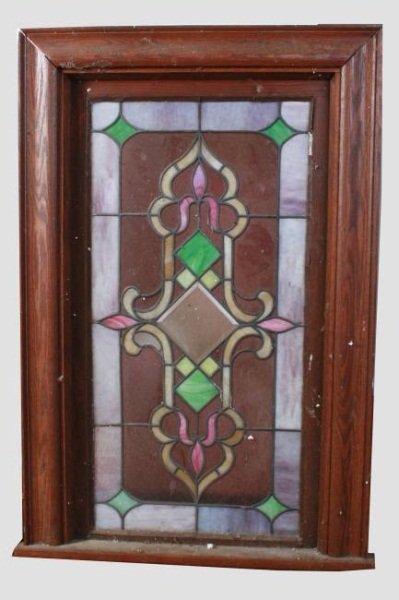 Stained Glass Window, Early 20th C.: Stained glass window. American, early 20th century. Stained glass panel in a window frame. Glass in a rectangular geometric pattern. Frame height 45", width 28", depth 6". Condition: Missing one leade