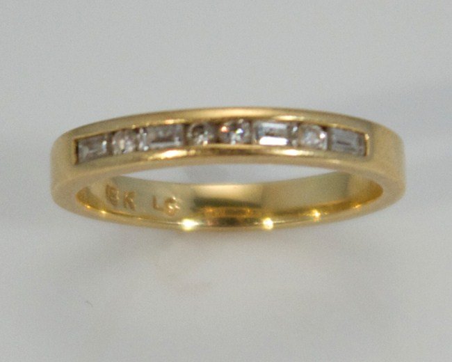 18K Gold Ring with Diamonds: 18 Karat Yellow Gold Ring With Diamonds. 20th Century. 18 Karat Gold Band Channel Set With Eight Diamonds, 02 Ct. Total Weight. 18 Karat Gold Weight 2.4 Grams. Size 4 1/2. Condition: Appears fine.