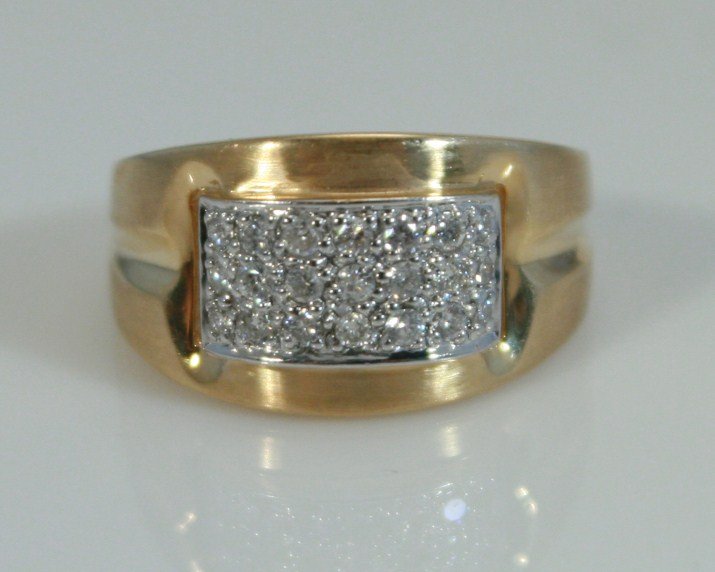14K Gold Band with Diamonds: 14 karat yellow gold band with diamonds. 20th century. 14 karat gold band with 21 diamonds, 0.33 ct. total weight. Ring size 6 1/2. 14 karat gold weight 5.0 grams. Condition: Appears fine.