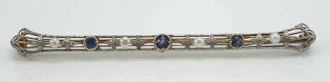 14K Gold and Platinum Edwardian Bar Pin: 14 karat white gold and platinum Edwardian bar pin. English, first quarter 20th century. 14 karat white and platinum bar pin having fluted ends and floral motif engraving set with three sapphires and