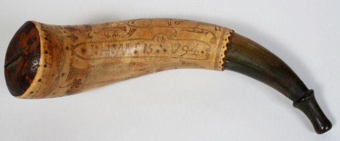 Scrimshaw Powder Horn, C. 1794: Scrimshaw powder horn. Circa 1794. Powder horn depicting wild animals and a gentleman wielding a musket with inscription reading "JHM 15 1794". Length 12 1/2". Condition: Wear and yellow patina consis