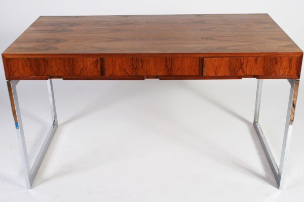Milo Baughman Rosewood and Chromed Steel Desk: Milo Baughman rosewood and chromed steel desk. Desk with rosewood top fitted with three blind drawers over chromed steel base. Height 29 1/2", width 52", depth 26".