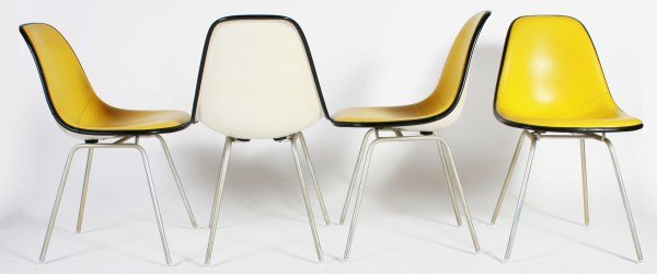 Group of 4 Charles & Ray Eames Padded Shell Chairs: Group of four Charles and Ray Eames padded shell side chairs. American, 20th century. Made by Herman Miller. Fiberglass shell side chairs with yellow ochre vinyl upholstery on four tubular metal legs.
