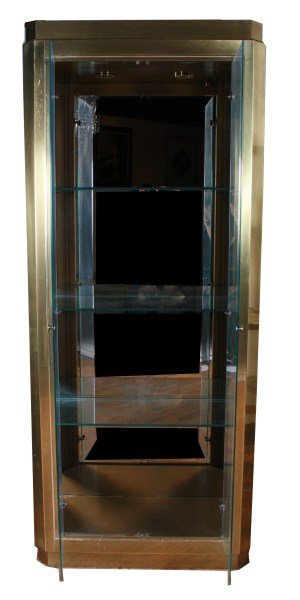 Mastercraft Vitrine: Mastercraft vitrine cabinet. American, 20th century. Designed by Bernhard Rohne. Brass vitrine cabinet with glass doors and sides. Fitted with three adjustable beveled glass shelves and recessed light