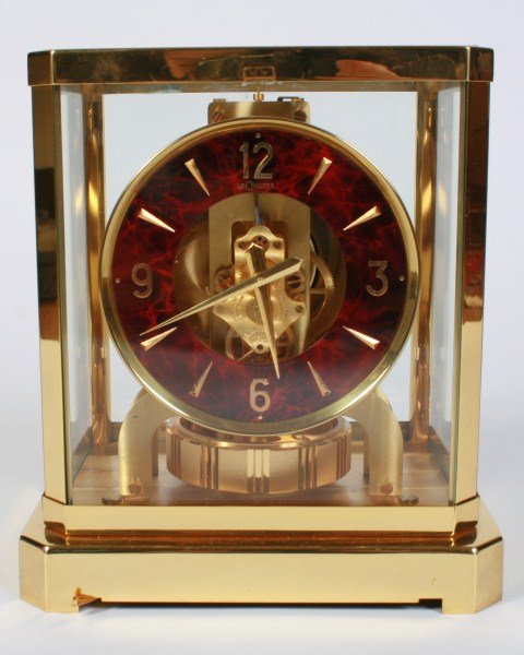 Jaeger-LeCoultre Atmos Clock: Jaeger LeCoultre Atmos clock. Swiss, 20th century. Polished brass and glass paneled flip-front case with tortoiseshell enamel dial. Height 9 1/8", width 8 1/4", depth 6 1/2".