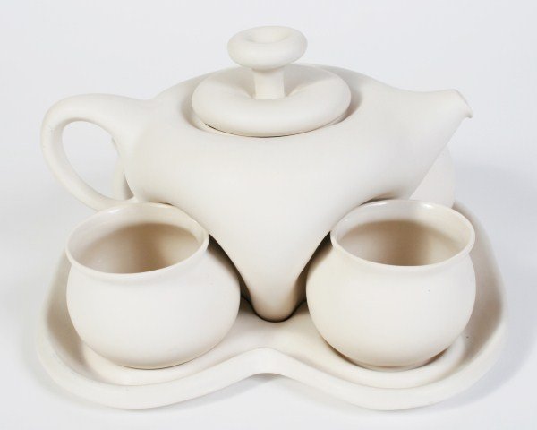 Peter Saenger Porcelain Tea Set, 20th C.: Peter Saenger tea set. American, 20th century. Six piece porcelain tea set with a white matte glaze includes one teapot, four tea cups without handles, and an associated tray. Teapot and tea cups all