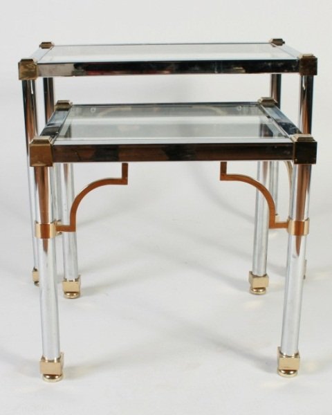 Pair Chrome and Brass Nesting Tables, Circa 1970: Pair chrome and brass nesting tables. Circa 1970. Rectangular chrome frames with inset glass tops and brass plated accents. Unmarked. Larger height 21", width 28", depth 21 1/4".