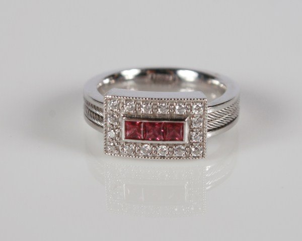 Charriol Flamme Blanche 18K White Gold Ring: Charriol Flamme Blanche 18 karat white gold ring set with three princess cut rhodolite stones surrounded by 16 round diamonds, total weight .20 ct. Ring size 6. Total weight 8.1 grams.