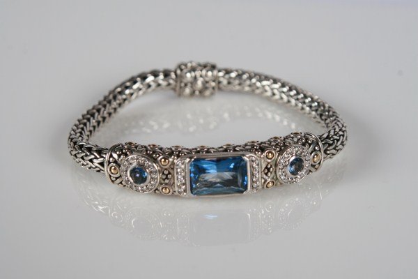 John Hardy Batu Sari Bracelet: John Hardy Batu Sari sterling silver and 18 karat yellow gold bracelet set with blue topaz and pavé diamonds, total weight .27 ct. Total weight 33.3 grams.