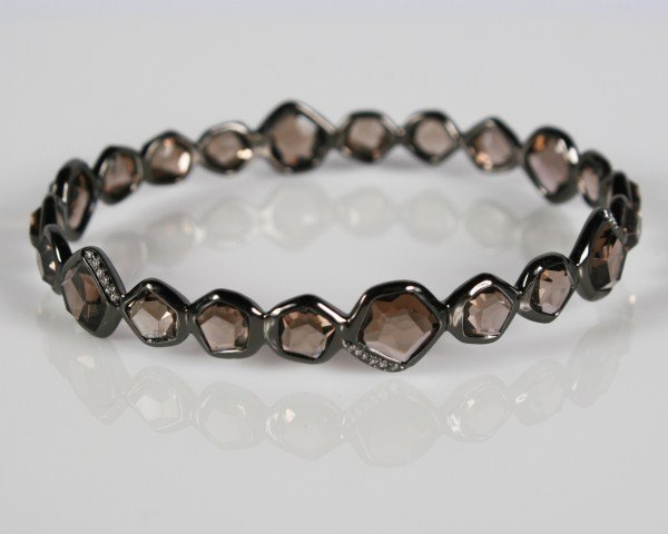 Ippolita Wicked Bracelet: Ippolita Wicked bracelet. 20th century. Rhodium plated sterling silver bracelet set with smoky quartz and diamonds, total weight .15 ct. Total weight 16.0 grams.